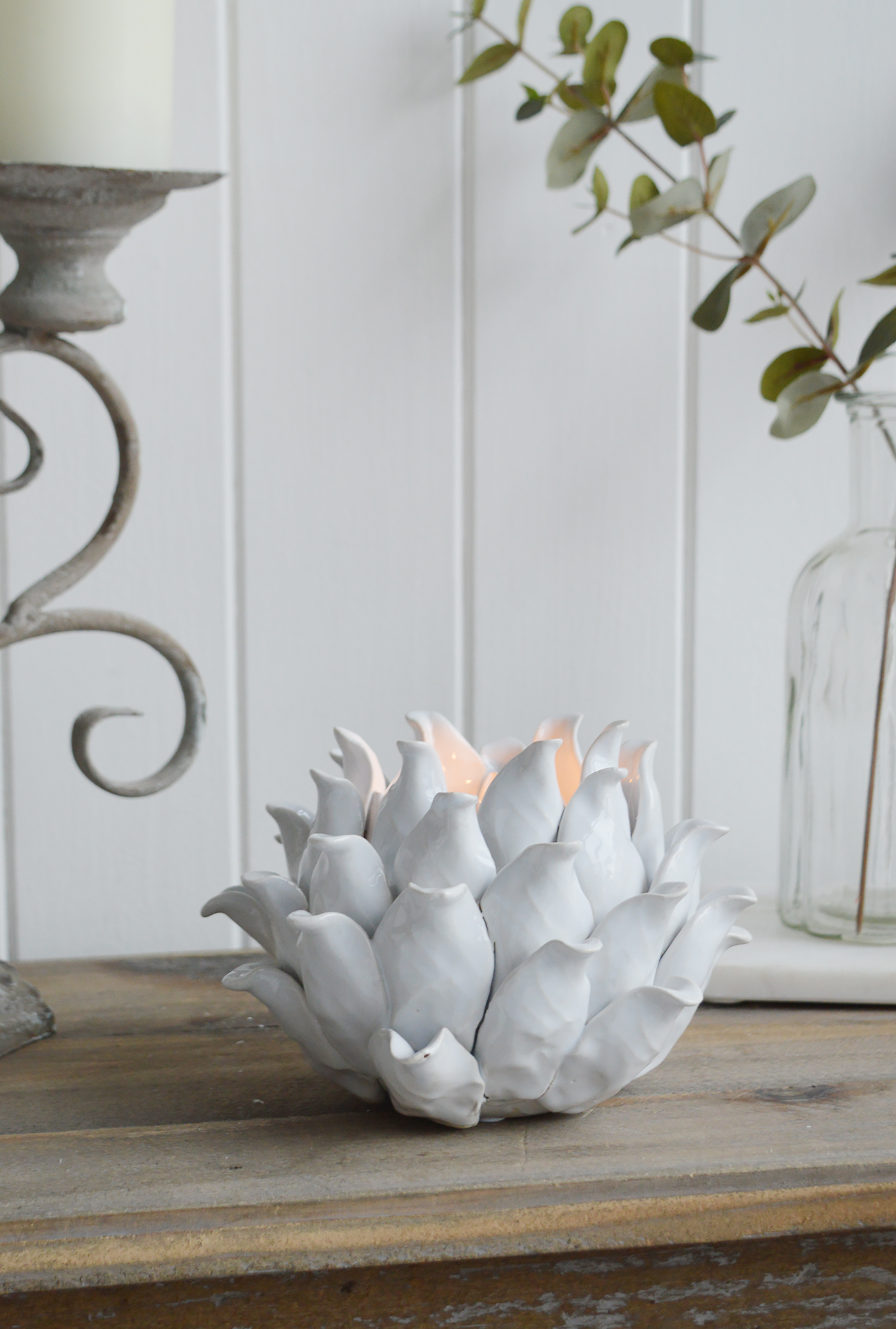 A white flower tea light holder from The White Lighthouse furniture and accessories. New England interiors. Home decor and furniture for coastal, country and city homes